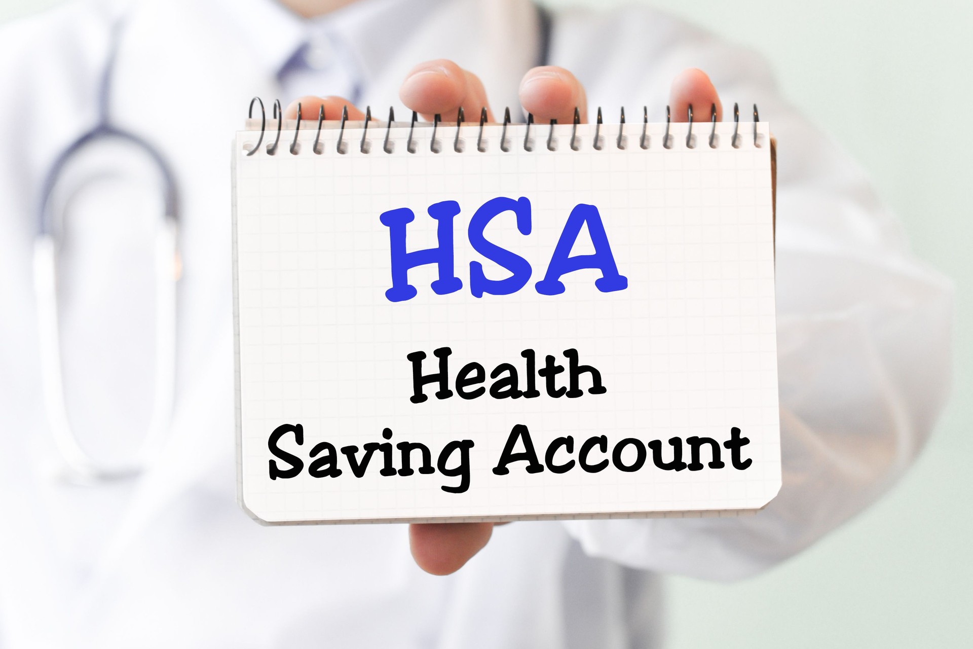 Doctor holding a card with text HSA Health Saving Account medical concept